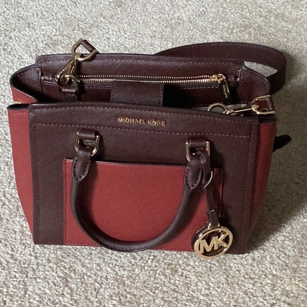 Michael Kors burgundy/brick colored handbag.